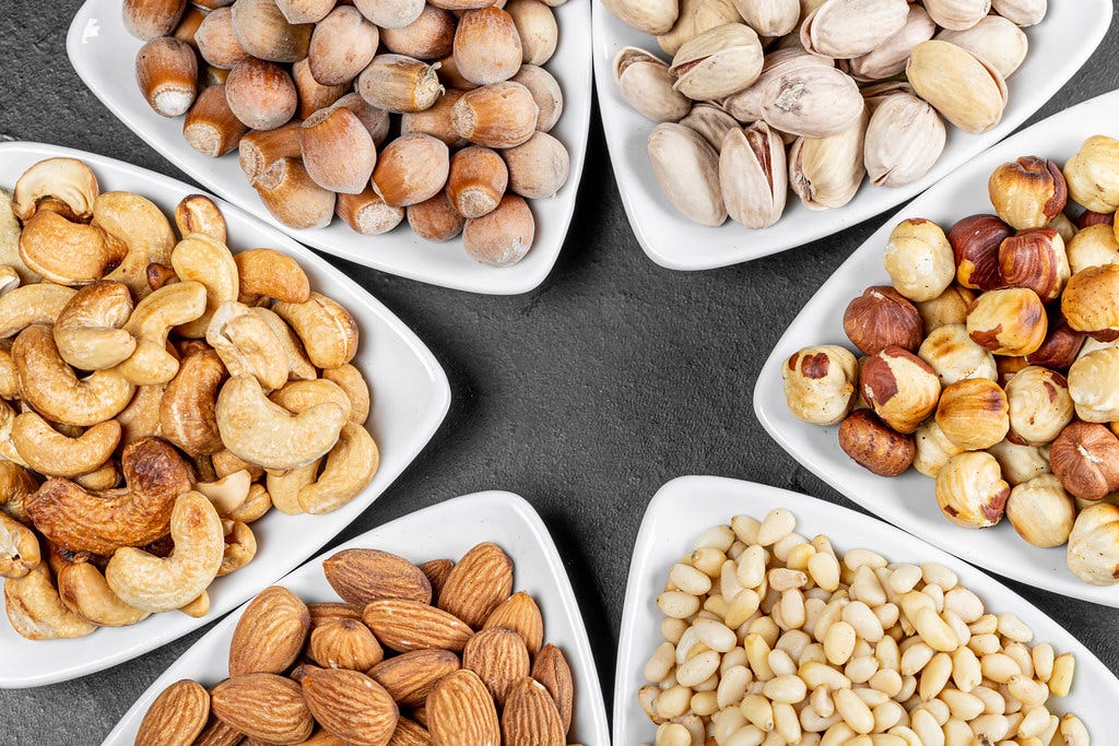 Almonds, Nuts, Cashews, Soy nuts, Pistachio, Dry fruits in white plates