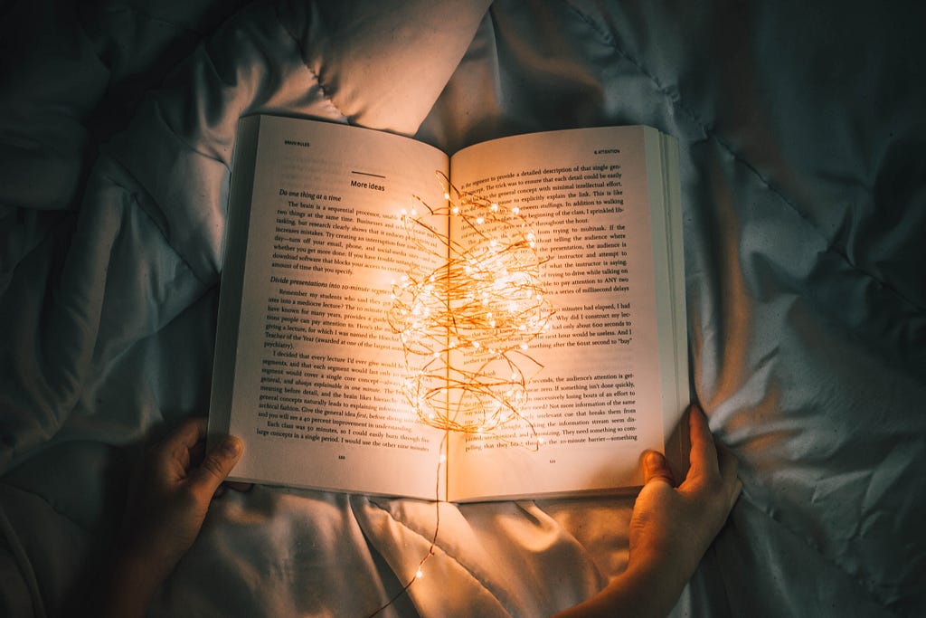 An open book with lights invites readers into a world of storytelling