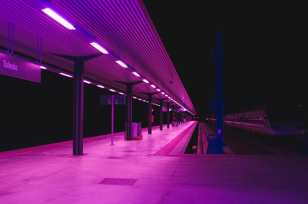 A train station platform at night