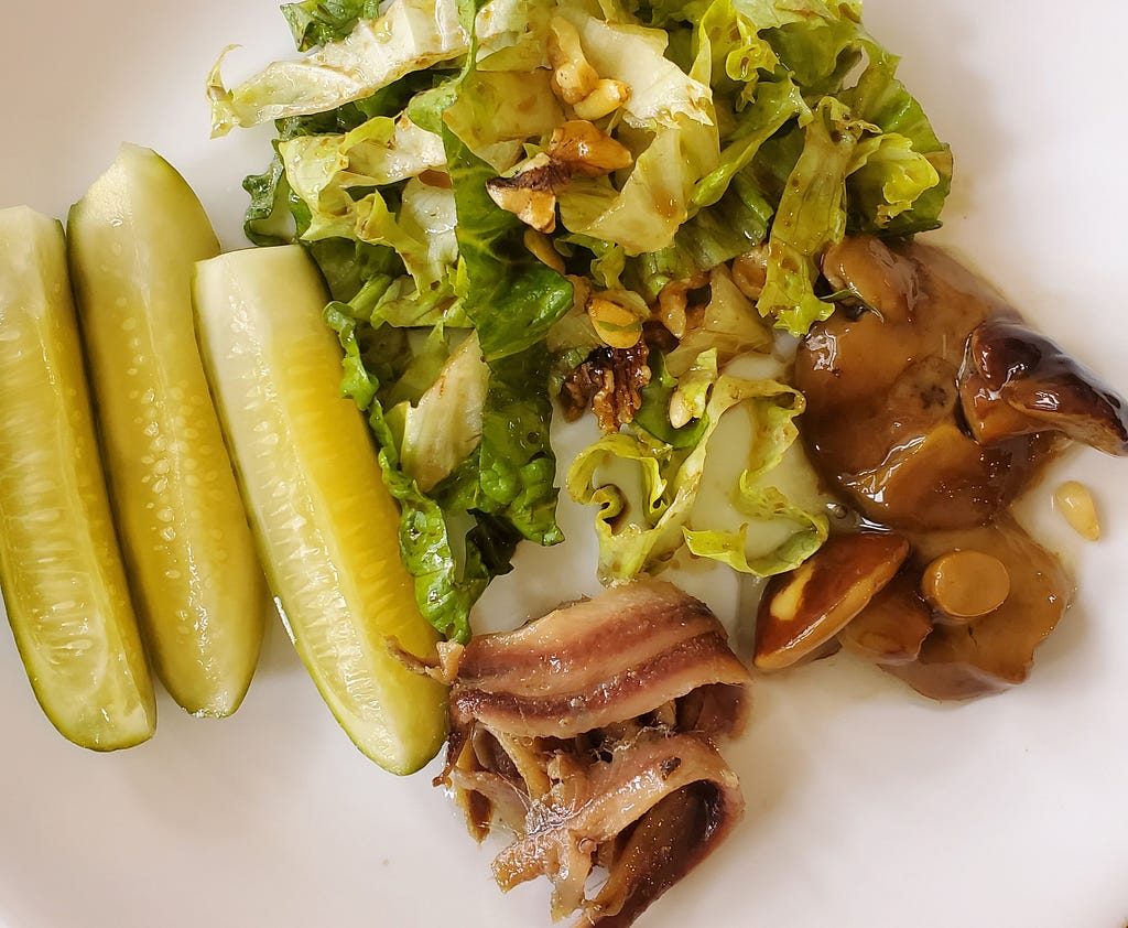 Pickles, leafy greens, olive oil, nuts, vinegar, anchovies in olive oil, mushrooms marinated in vinegar.