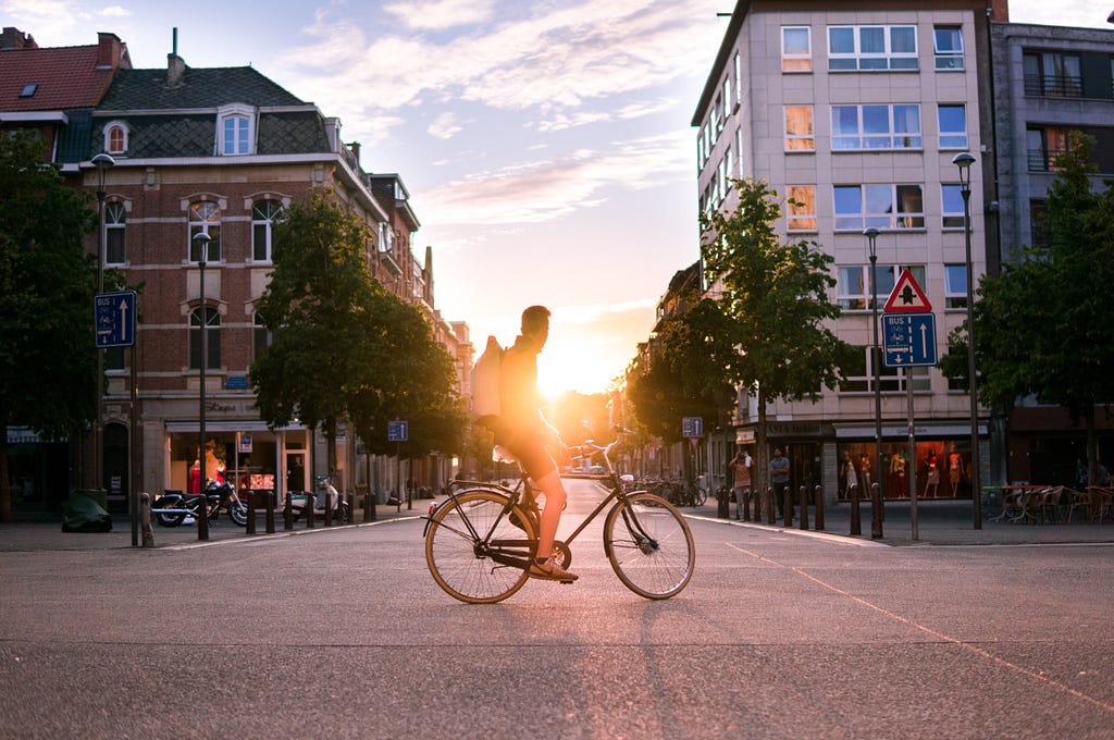 Man riding a bike at sunset