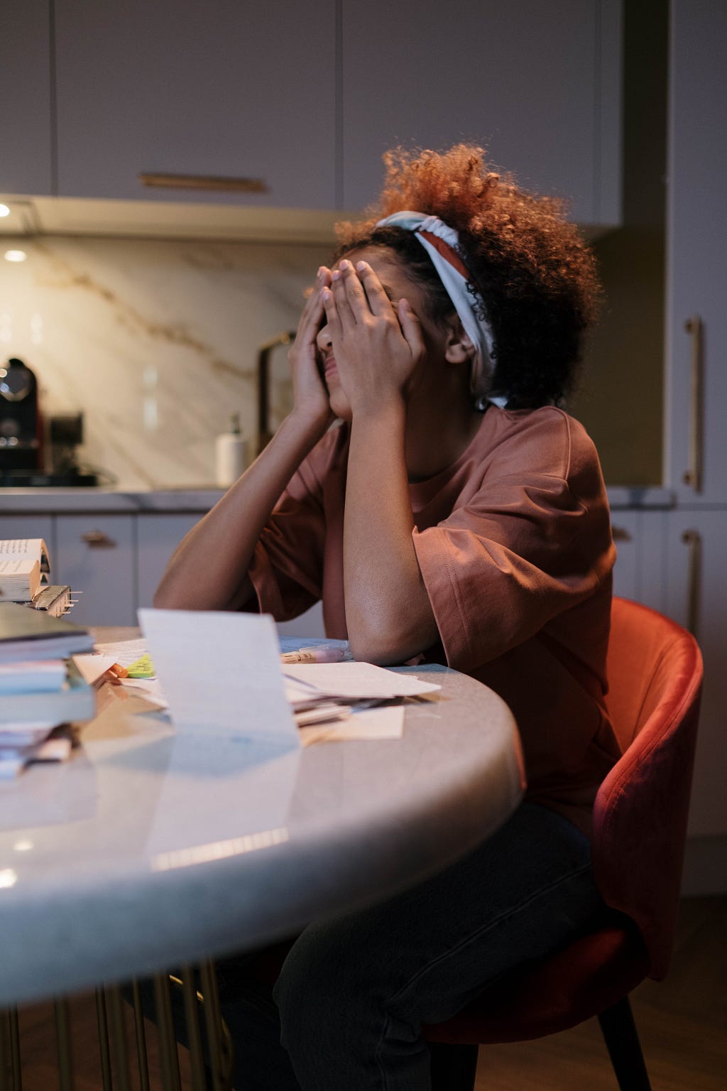 A child sitting revising for an exam looking stressed and anxious