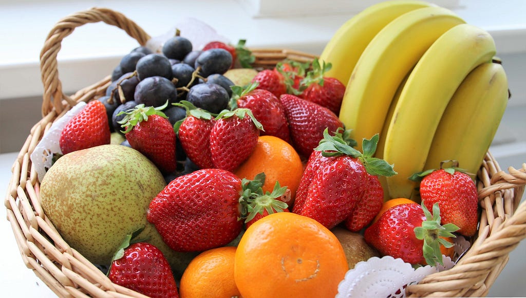 A basket of a variety of healthy fresh fruit.