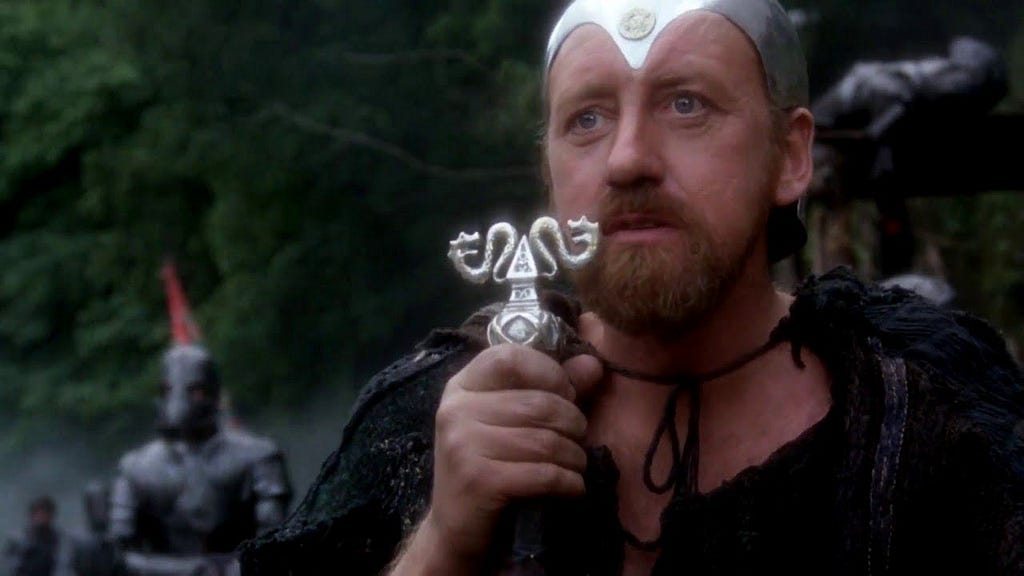 Merlin (Nicol Williamson) holding his wizard’s staff in Excalibur.