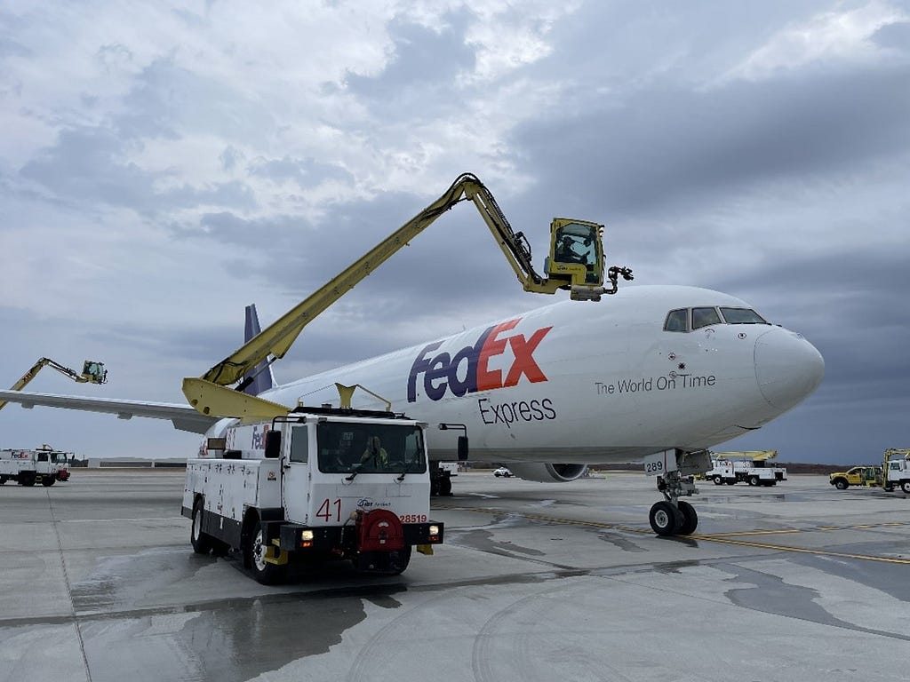 Crews de-ice a FedEx cargo plane.