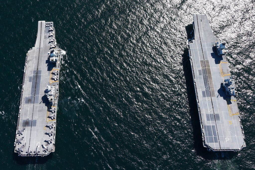 Earlier this year, HMS Queen Elizabeth (left) and HMS Prince of Wales (right) met at sea for the first time.