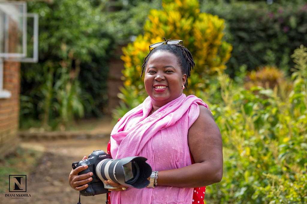Portrait of Levina Kinyaiya, a Tanzanian wildlife videographer, holding a camera as captured by Tanzanian photographer Imani Nsamila.