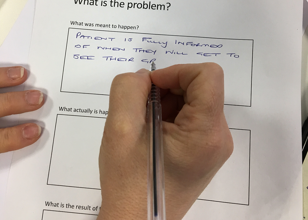 Participant writing a problem statement based on user research