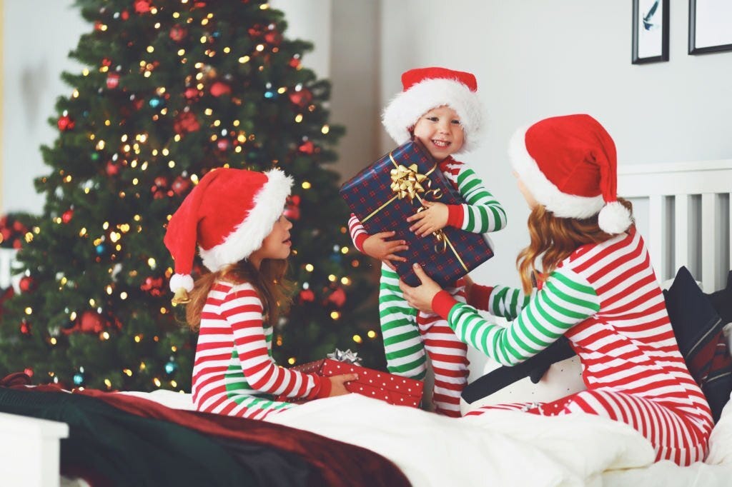 happy-family-mother-and-children-in-pajamas-opening-gifts-on-christmas-morning