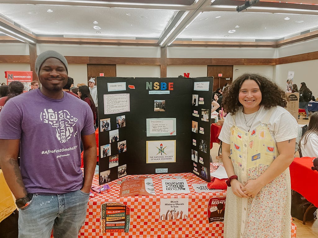 Elena and another NSBE member smile for a photo during the club fair as they tell other Huskers about their organization