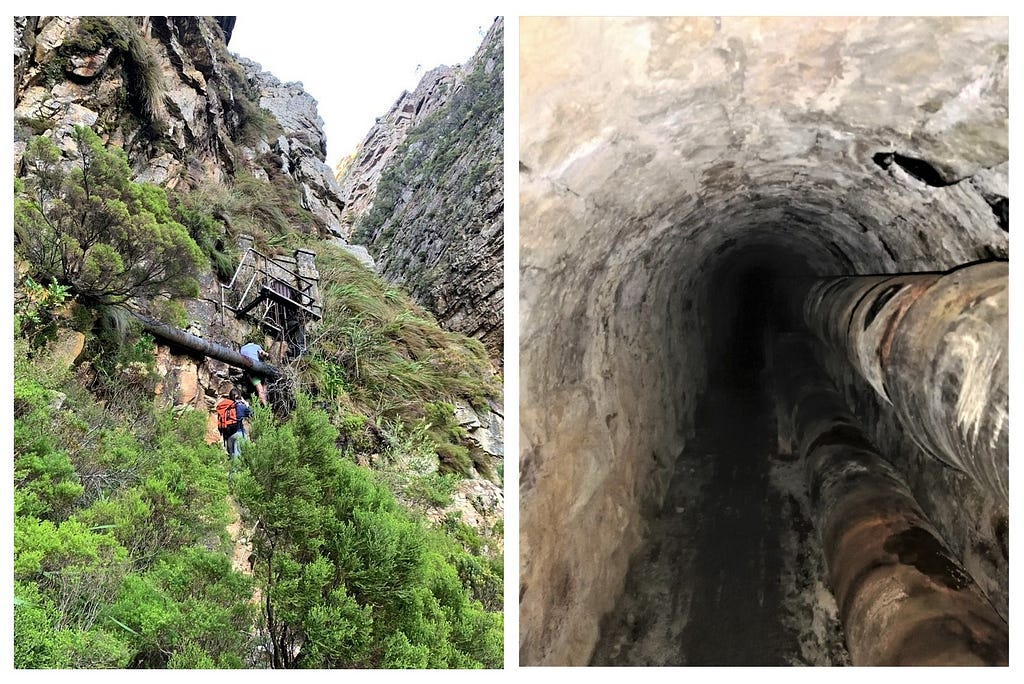 A mountainside and entrance to the tunnel on the left; the darkness of the tunnel stretching ahead on the right.