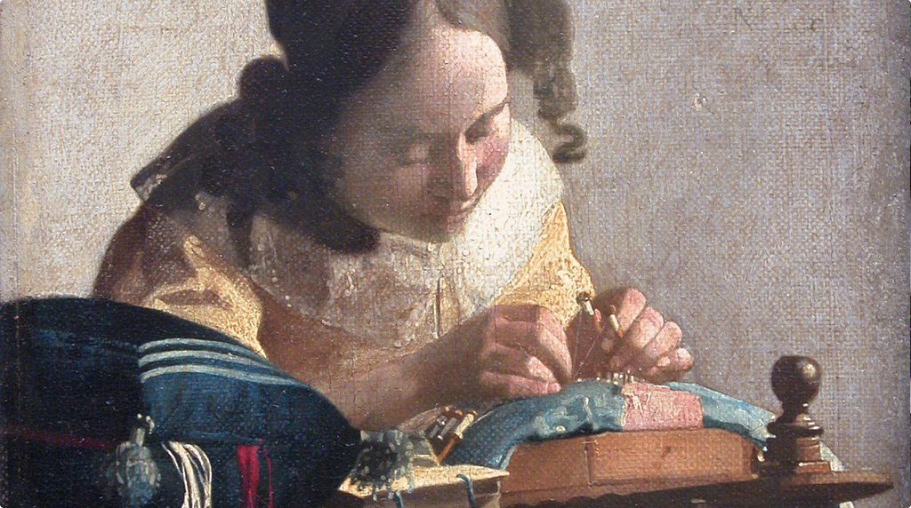Oil painting of a young woman in a yellow bodice bent closely over a lacemaking cushion, her hands precisely manipulating bobbins and thread. Her gaze is entirely fixed on the work. The background is plain and unadorned, drawing all attention to the act of making.