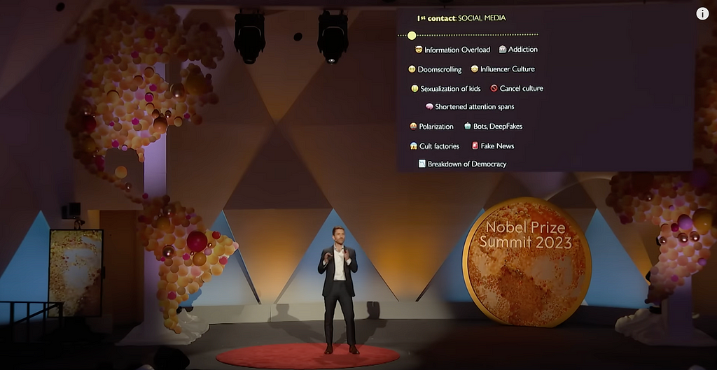 Photo of Tristan Harris speaking on stage at the Nobel Prize Summit in 2023, standing.