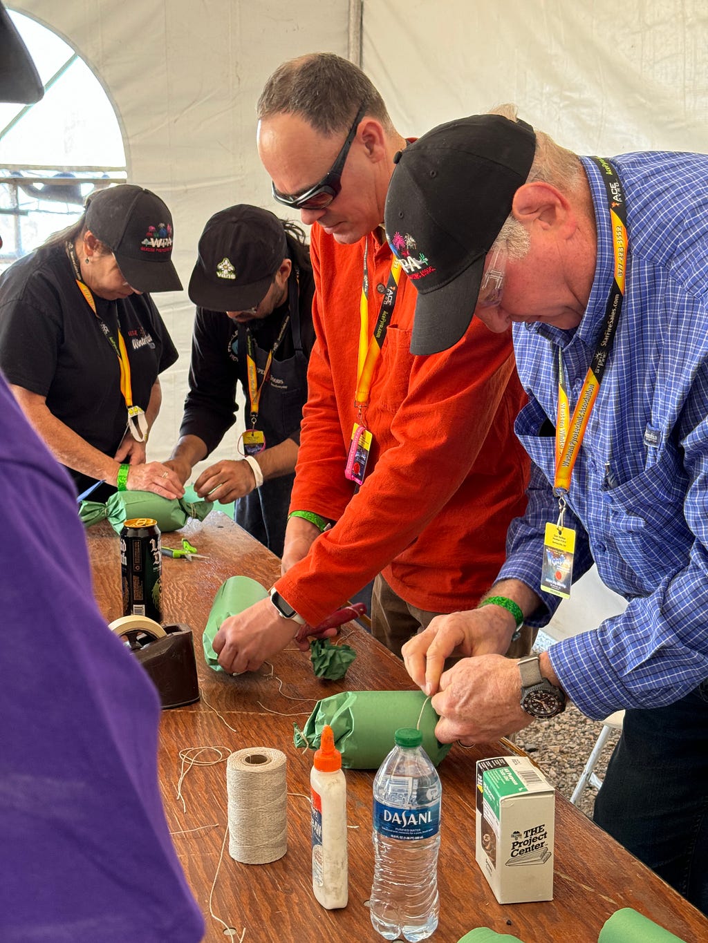 Four students making Italian shell fireworks at a work table.