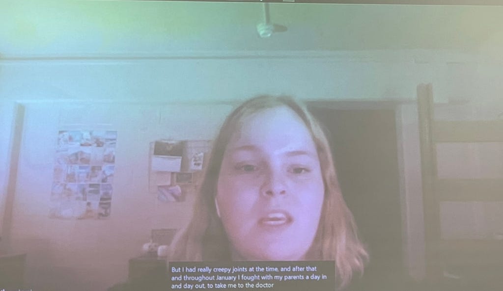 Student presents in their dorm room and subtitles are present on the screen