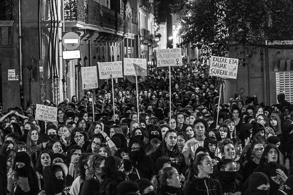 A large group of women protesting in a street