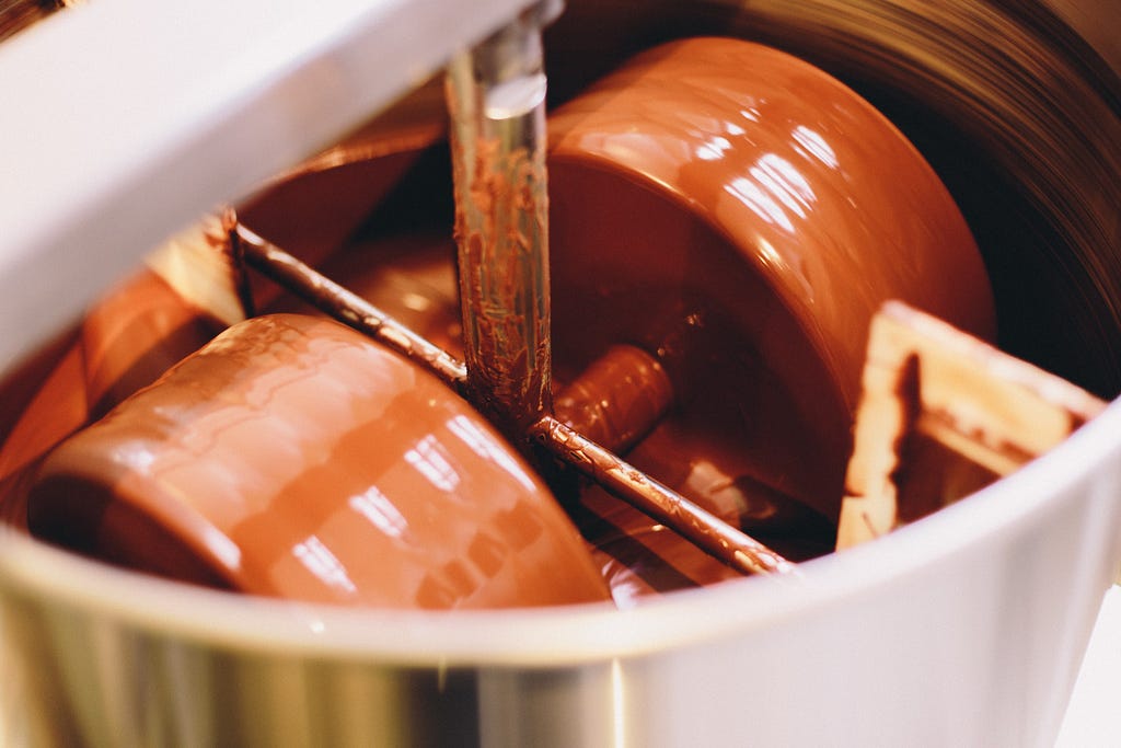Chocolate in a melangeur (chocolate-making machine).