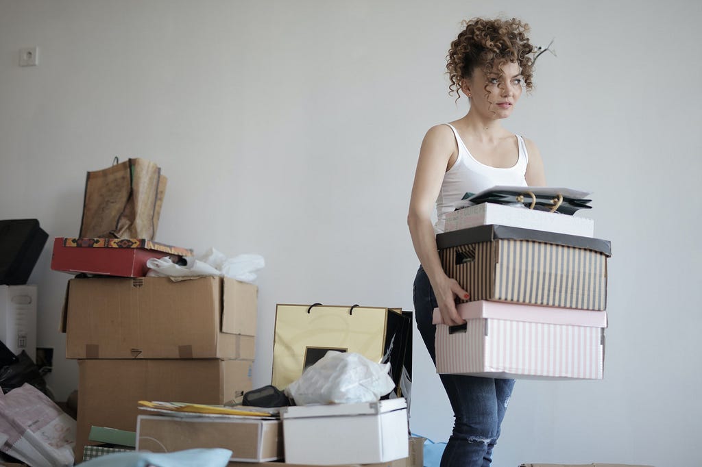 Woman carrying boxes of ‘psychic clutter’