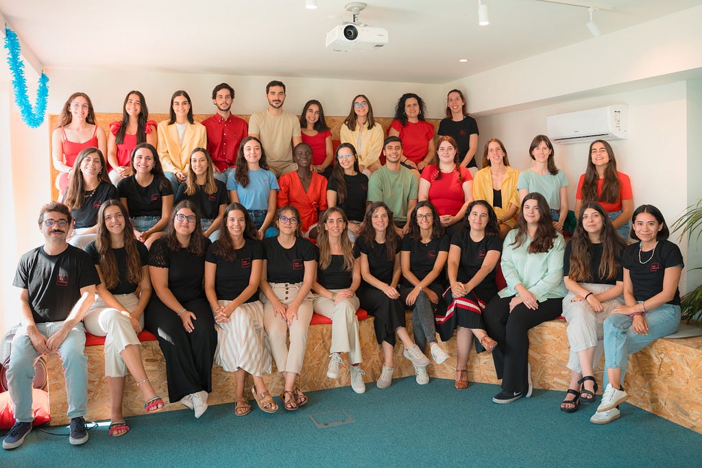 a team of work colleagues sat for a picture in an auditorium