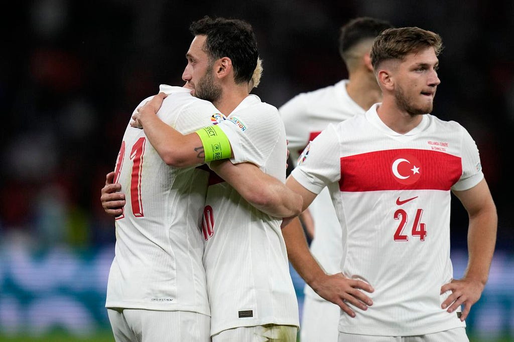 photo of Turkish players consoling each other