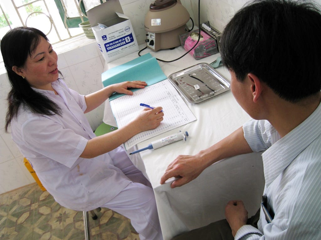 Nguyen Thi Chien interviews a client at a USAID-supported HIV testing and counselling center near Hanoi.