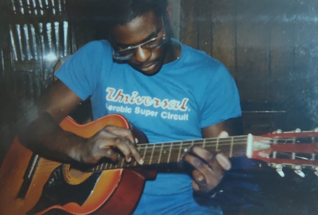 Playing my first acoustic guitar in high school