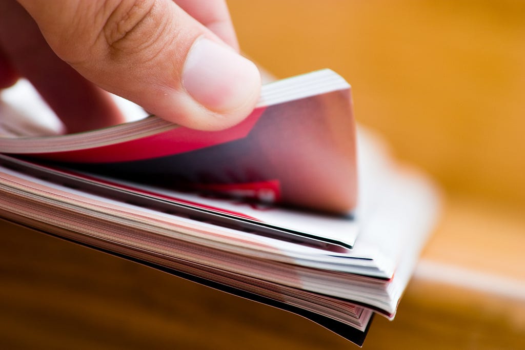 Zoomed in picture of someone thumbing through a stack of reports