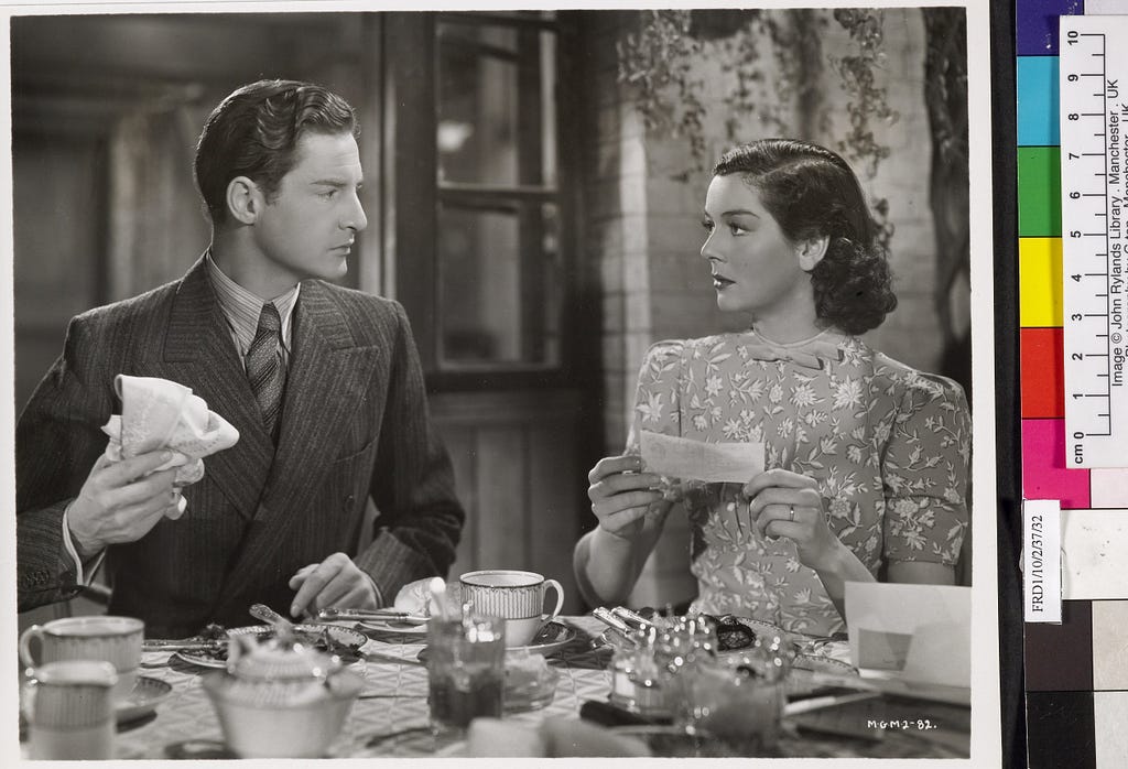 still from the film The Citadel showing Robert Donat and Rosalind Russell looking at one another over a table laid with dishes. He hold a napkin and she holds a letter. Alongside it is a colour chart.