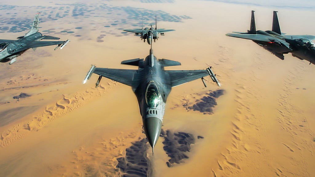 F-16 Fighting Falcons in formation with two Royal Saudi Air Force F-15E Strike Eagles, after receiving fuel from a KC-135R Stratotanker. Photo by Staff Sgt. Taylor Harrison/U.S. Air Force