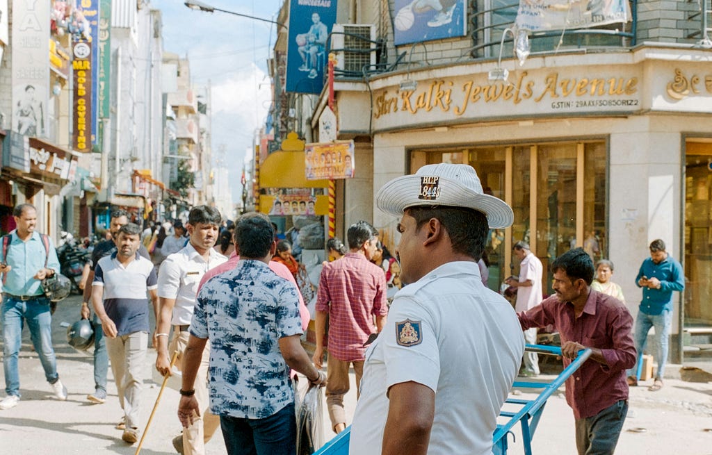 A traffic policeman in the middle of a chaotic and vibrant street in Bengaluru