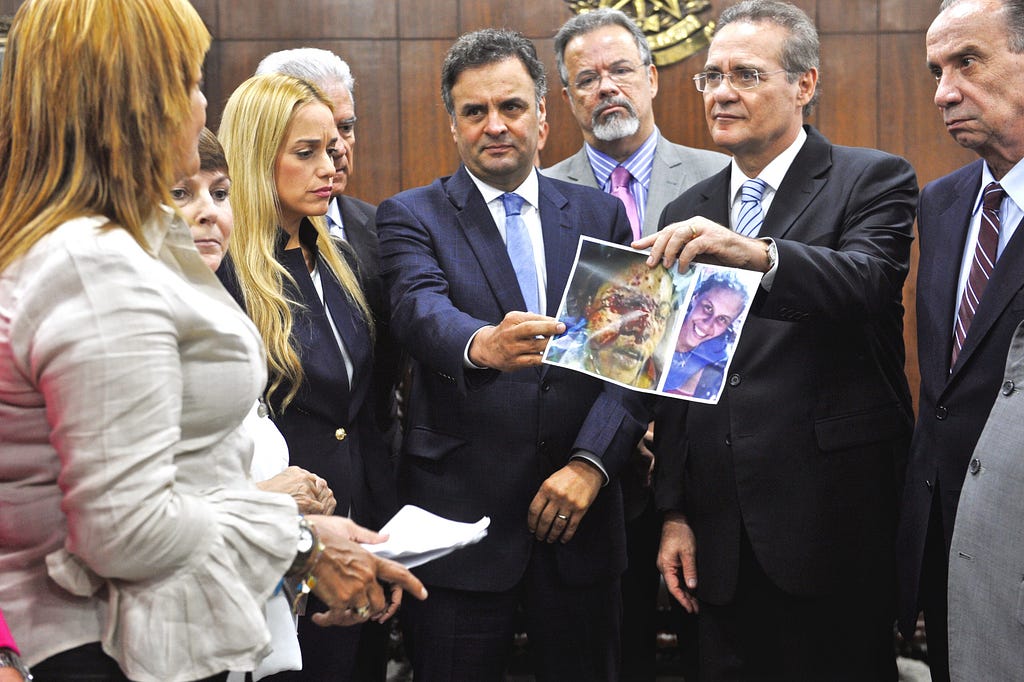 Lilian Tintori alongside Brazilian senators presenting a photo of Geraldine Moreno, who was killed after being shot in the face by Venezuelan authorities armed with birdshot.