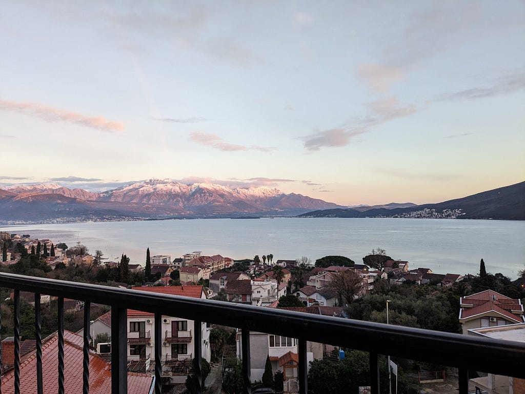 A sunset view of the bay from our balcony, looking across at the snow-capped mountains of Lovćen national park.