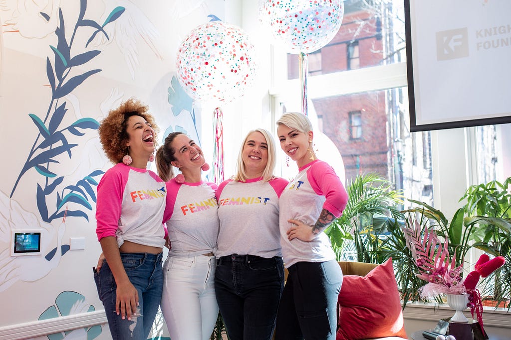 The four co-founders of The Coven smiling and laughing at a celebration in early 2020.