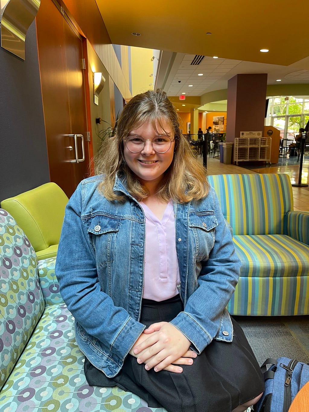 Laura Hopkins, sophomore at Saint Louis University, sitting and smiling in the Busch Student Center on Saint Louis Universities’ campus on August 31st, 2022 at 2:15 pm. Photo by Lauren Morby