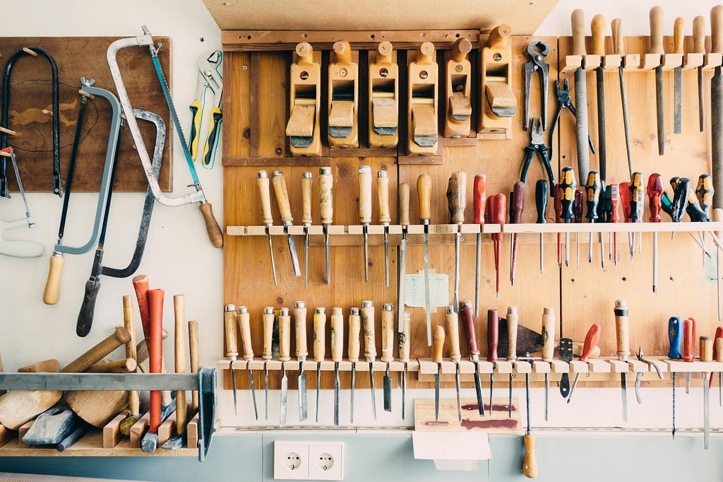 A carpentry workshop with many neatly organised tools.