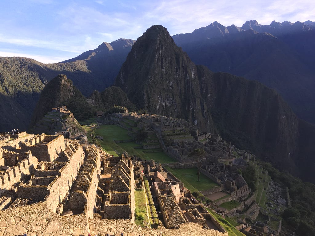 Sunrise over Machu Picchu in Peru, overlooking the mountains, jungle and clear sky.