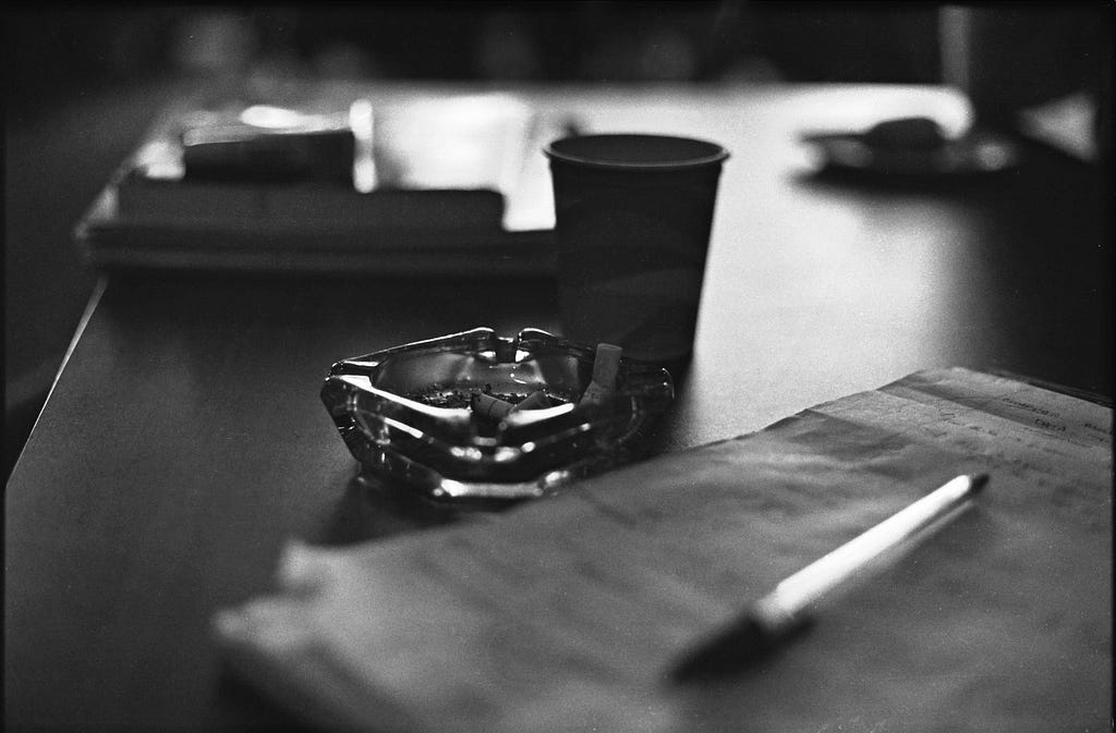 Photograph of Patty’s cigarette butts in an ashtray, along with her note pad, taken sometime in 1979 in Bowling Green State University’s Student Union.