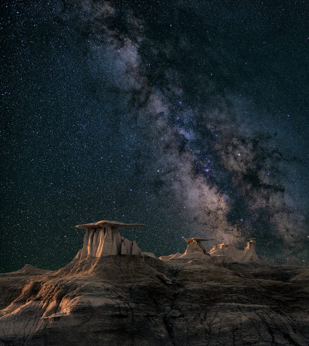 Stars set against an alien-looking desert landscape — photo by John Fowler and Unsplash.