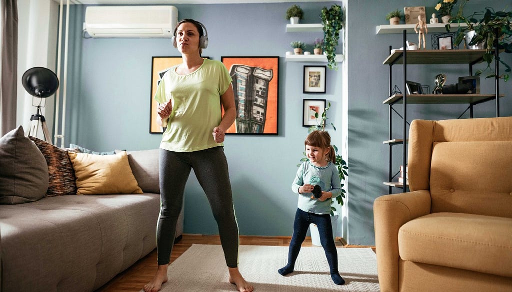 Mother and daughter exercising in the living room.