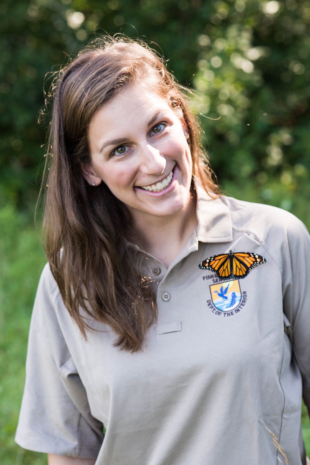 FWS Behind the Lens photographer and Multimedia Producer for External Affairs, Kayt Jonsson, is smiling big with a Monarch butterfly