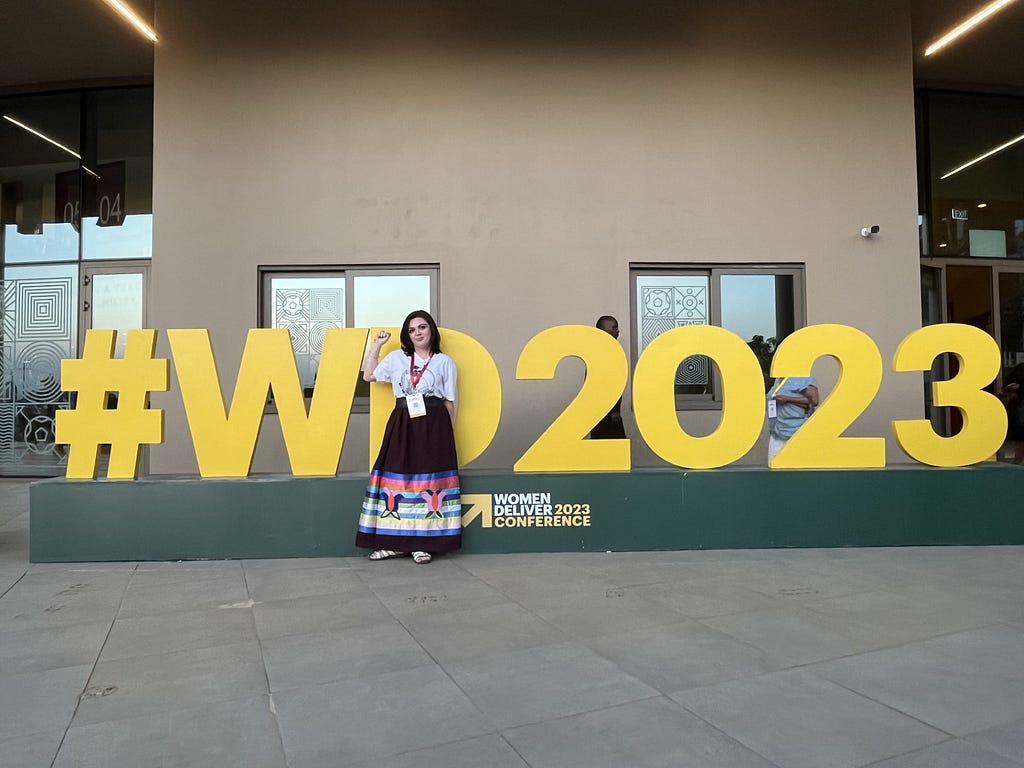 Woman in front of #WD2023 sign.