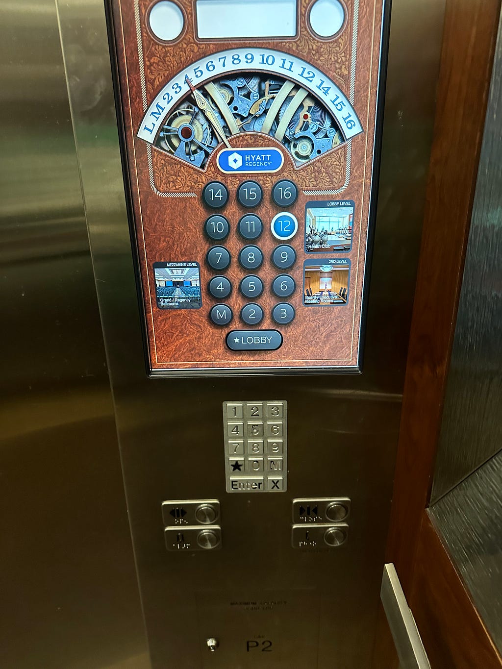 Elevator control panel showing a graphic and a keyboard.