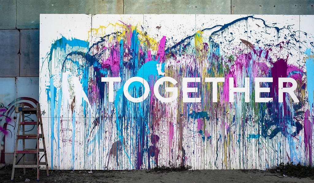 A painting of the word “together.” Whole Communities–Whole Health is a grand challenge at The University of Texas at Austin.