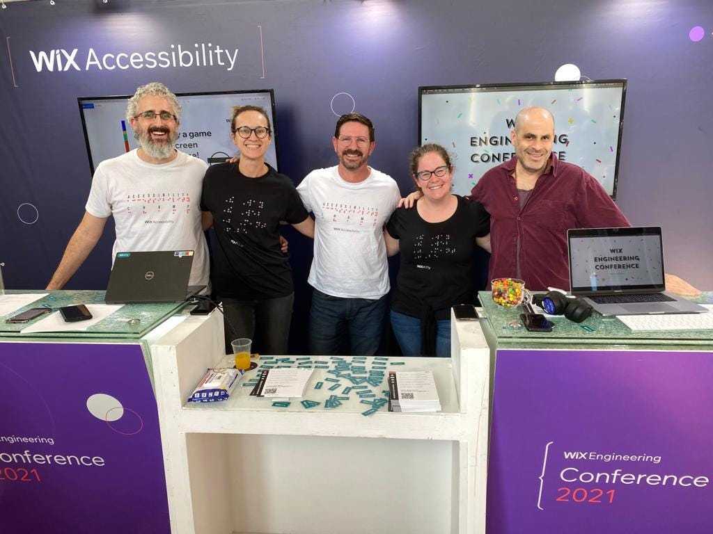 Wix’s accessibility team (5 people) in front of their booth at Wix’s engineering conference in 2021.