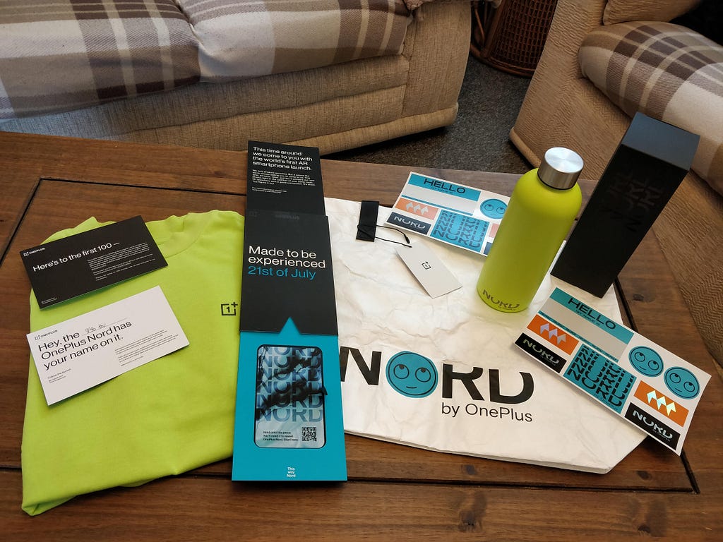 OnePlus Nord merchandise including a t-shirt, tote bag, flask and stickers.