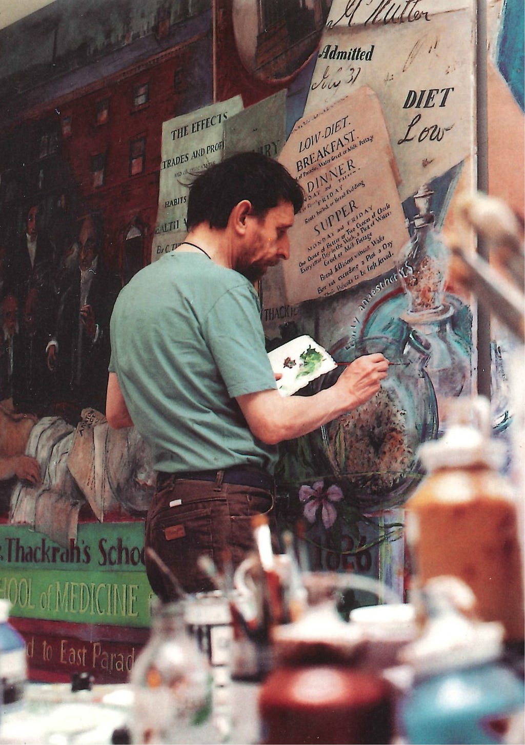 An artist painting a mural on a wall