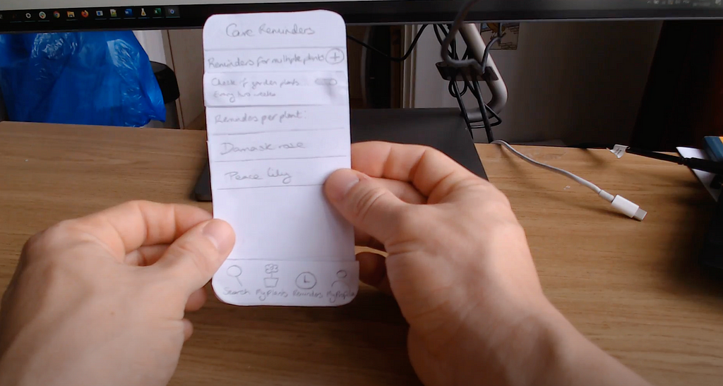 shot of video recording of user testing the paper prototype