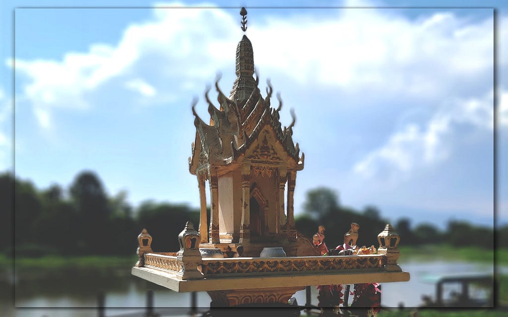 A photograph of a stupa placed next to the Ping River in Chiang Mai.