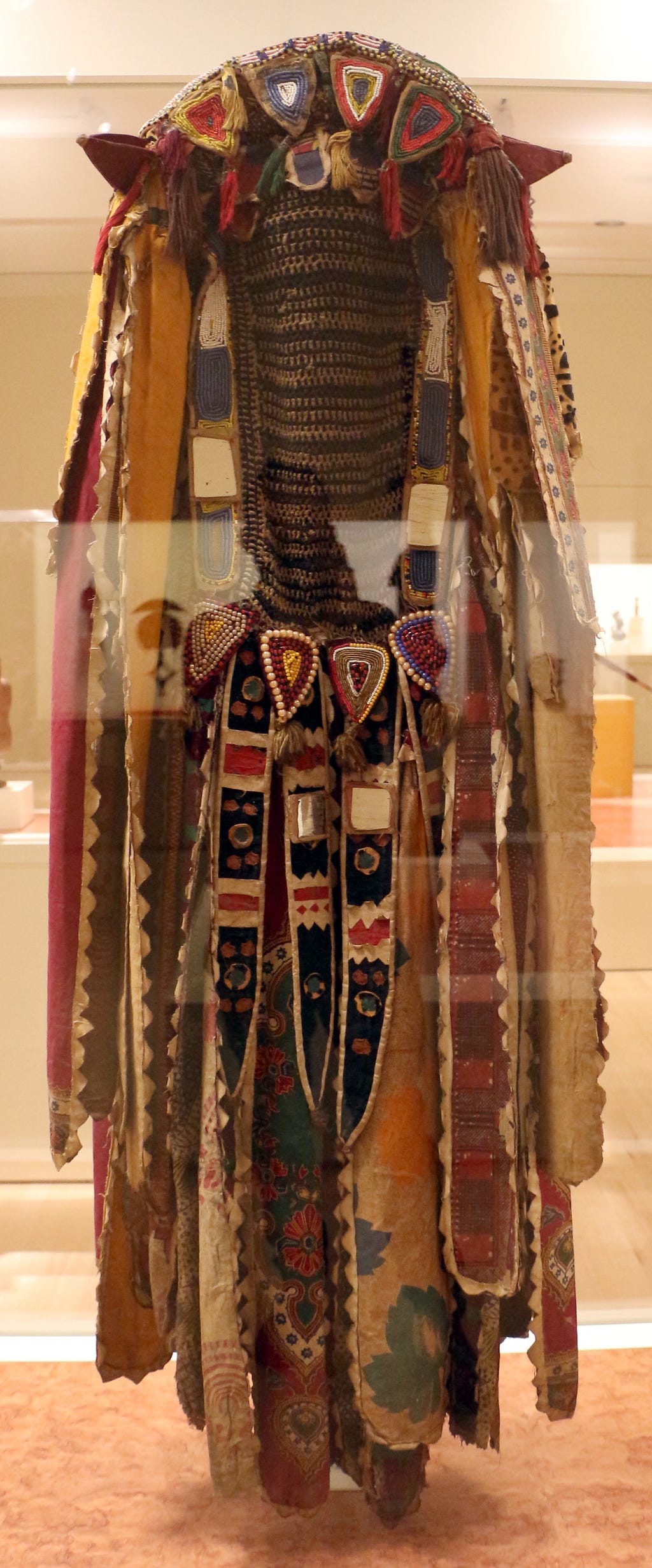 The image features an Egungun mask from Nigeria from ca. 1950