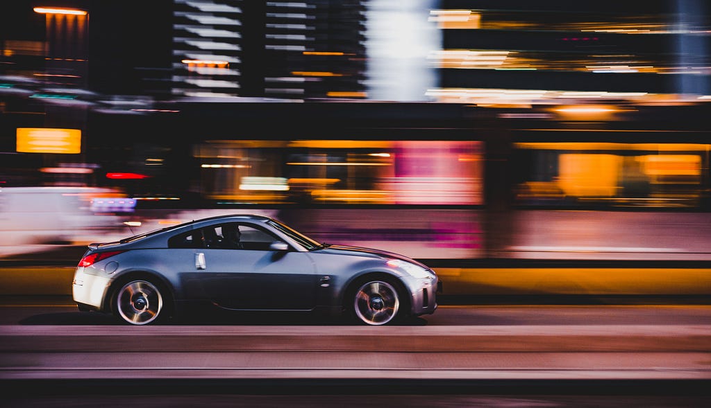 Nissan 370z speeding along a road in the city